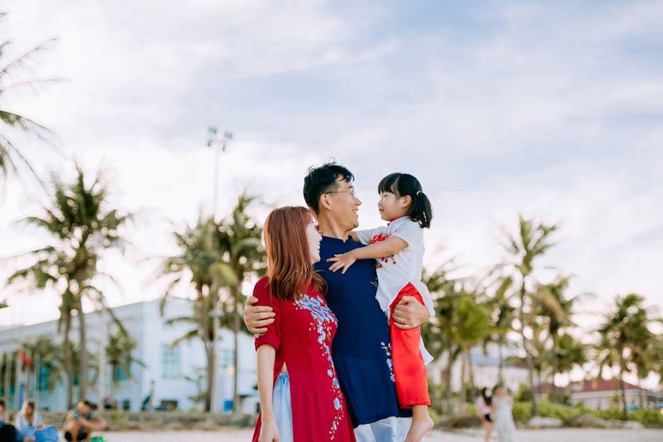 Smiling family of three spending quality time outdoors on a sunny day at the beach.