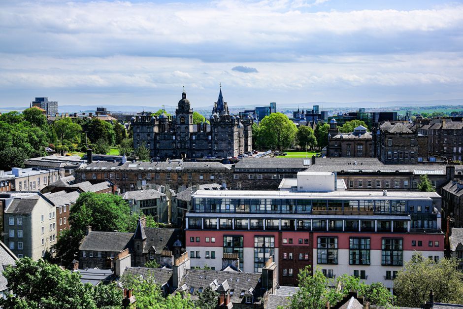 A scenic view of Edinburgh, Scotland showcasing historical architecture and greenery.