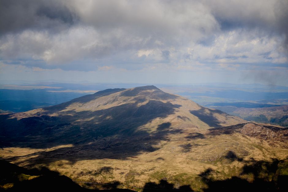 Captivating view of a mountainous landscape under dramatic clouds in Wales.