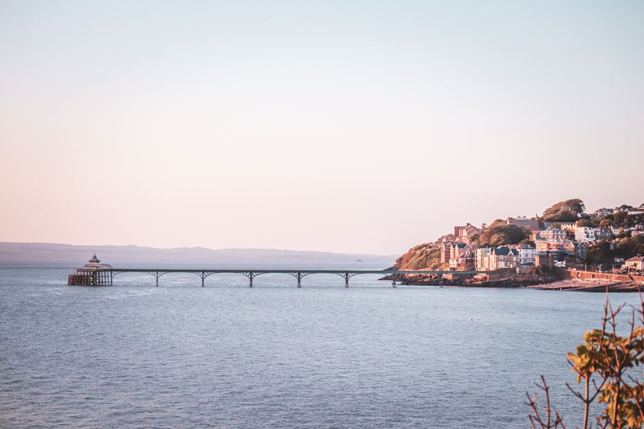 Serene coastal view of Clevedon Pier and colorful seaside town under a soft sky.