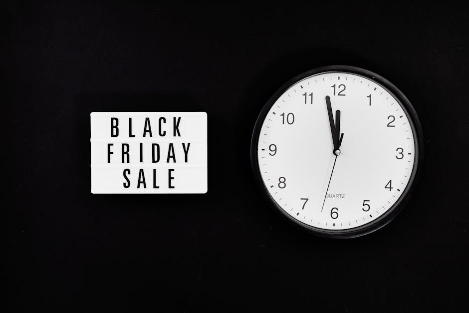 Minimalist clock with a Black Friday sale sign on black background, highlighting a midnight sale countdown.