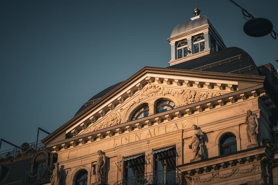 Stunning neoclassical facade of Eden au Lac hotel in Zurich during sunset.